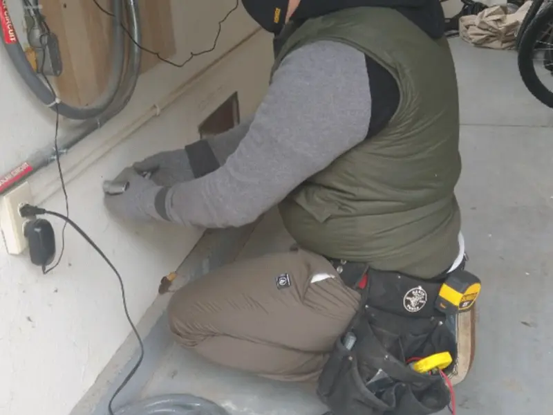 Electrician performing outlet wiring in a Grosse Pointe Farms garage